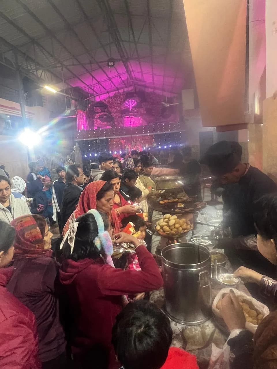 Devotees serving sacred prasad to children
